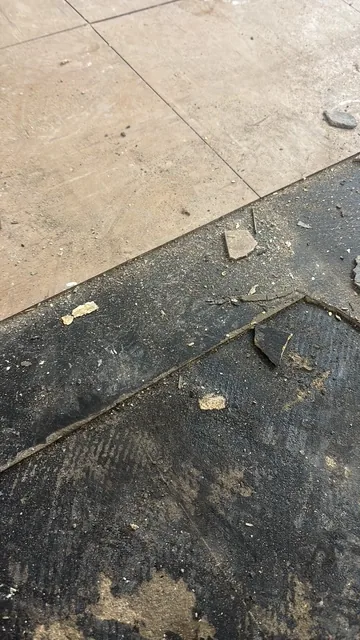 Black bitumen mastic floor removal in a E10 flat